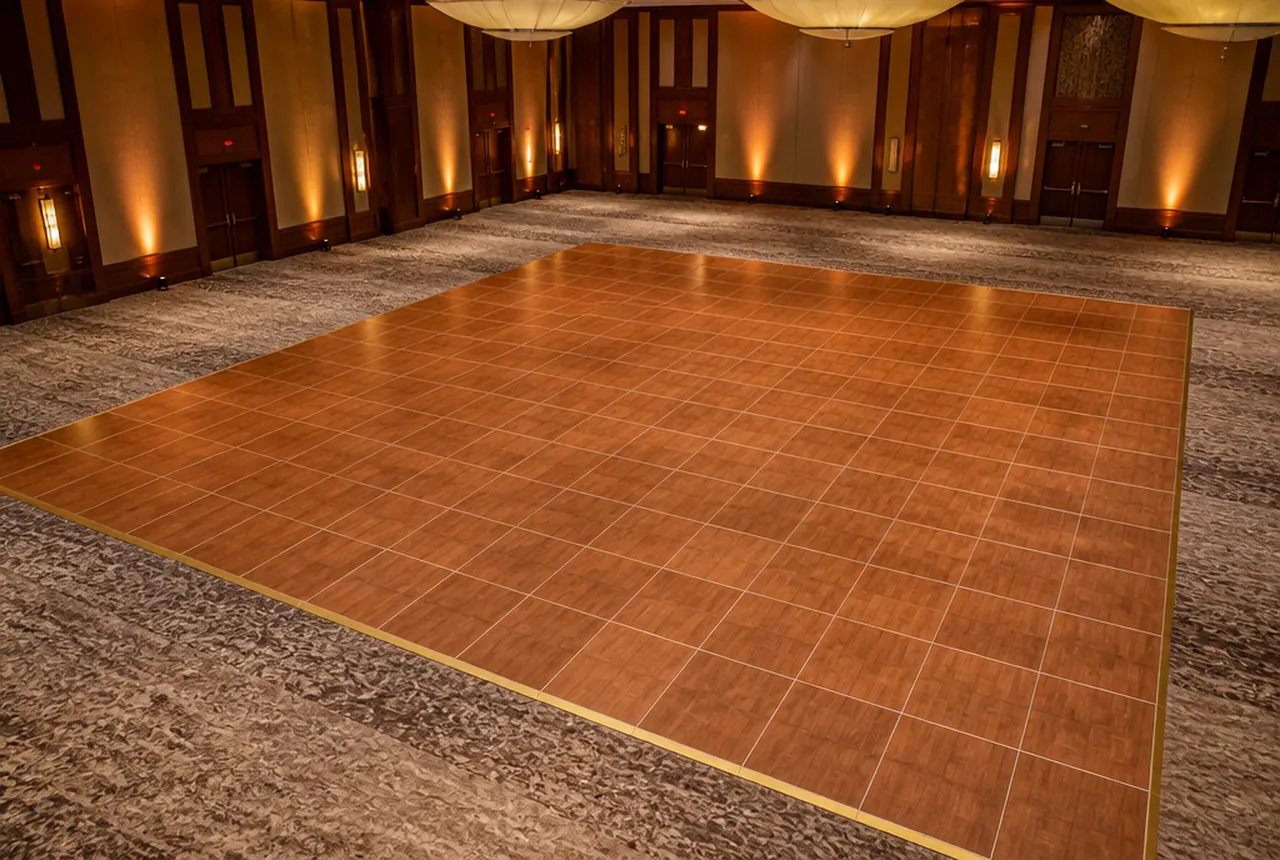A wood-look dance floor with perimeter trim in a carpeted event room