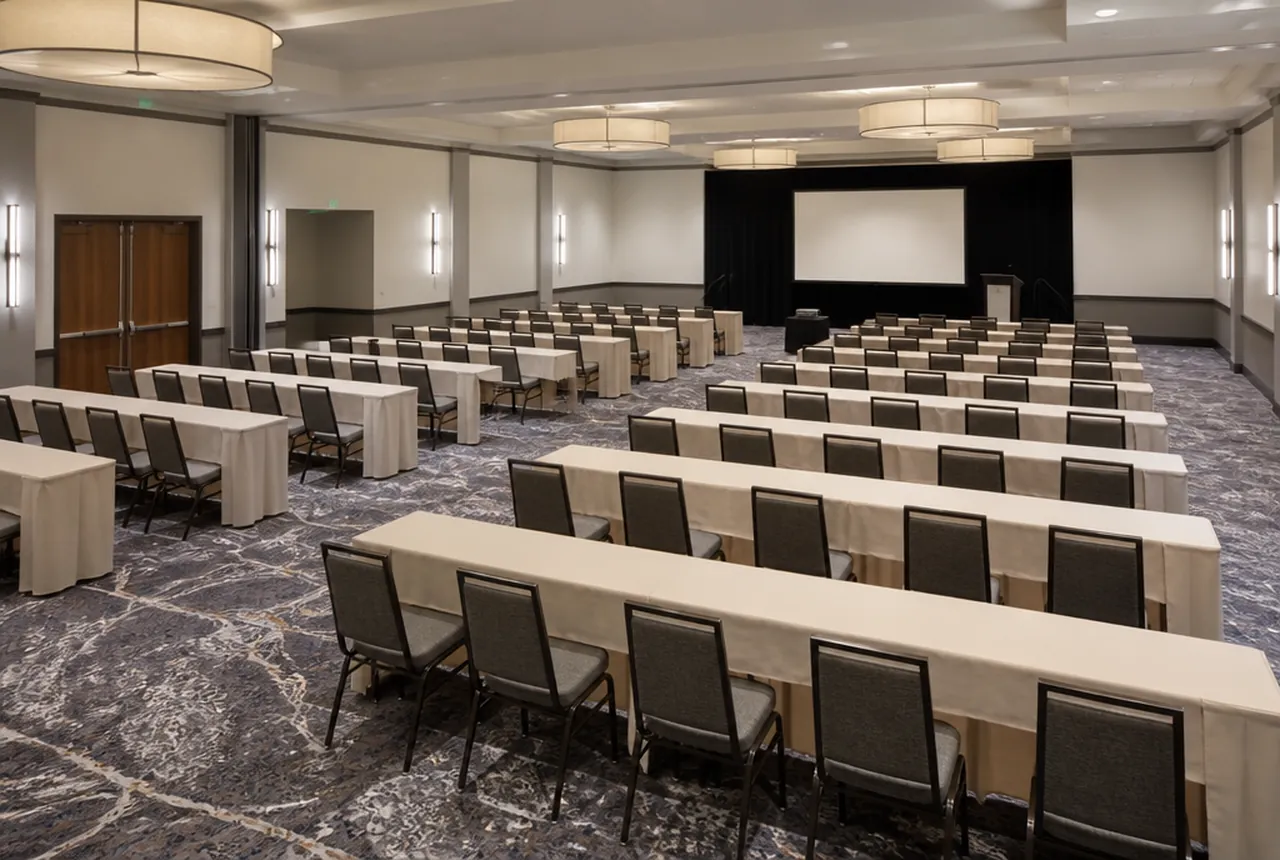 Classroom style setup with rectangular tables in ranks, chairs on the front side only, all facing forward